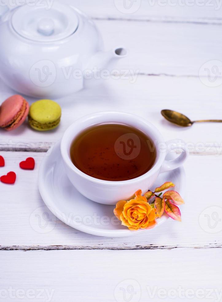 black tea in a white round cup with a saucer photo