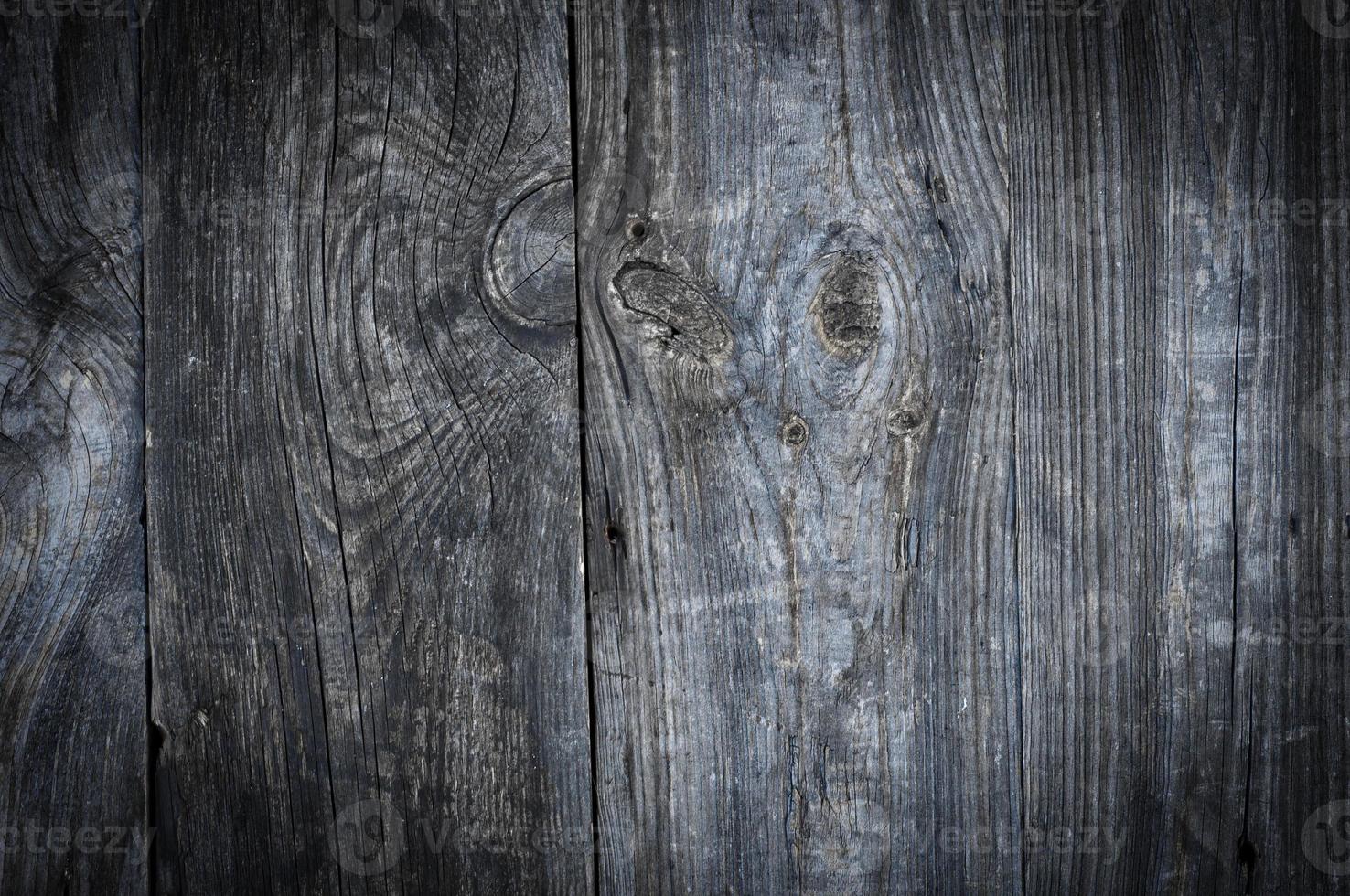 Gray old wooden background with knots and cracks photo