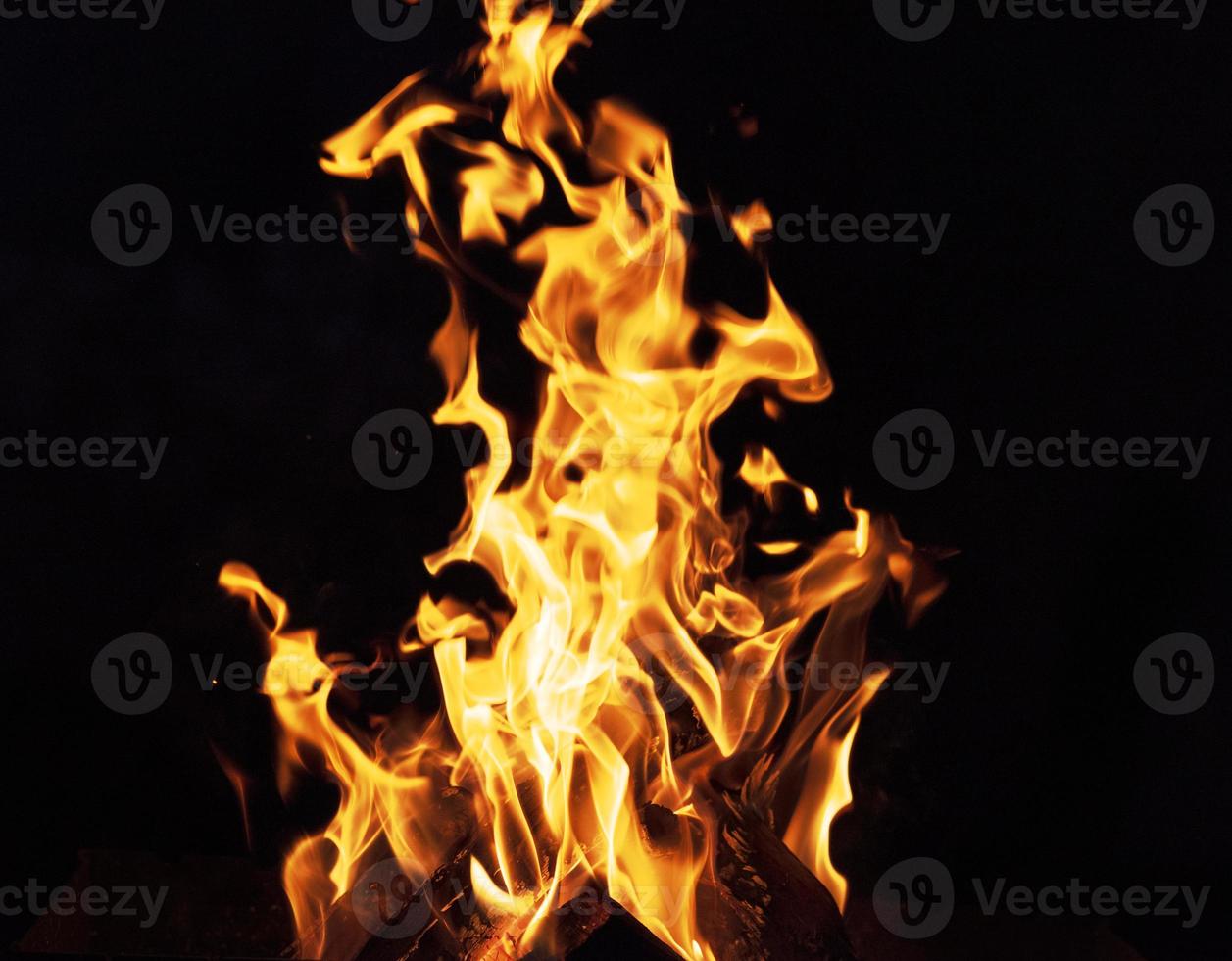 burning wooden logs and large orange flame photo