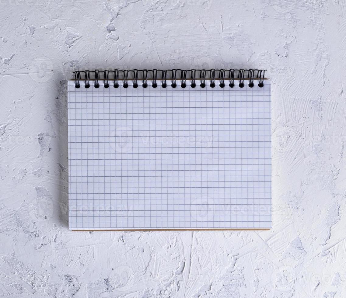 open notebook with blank white sheets photo