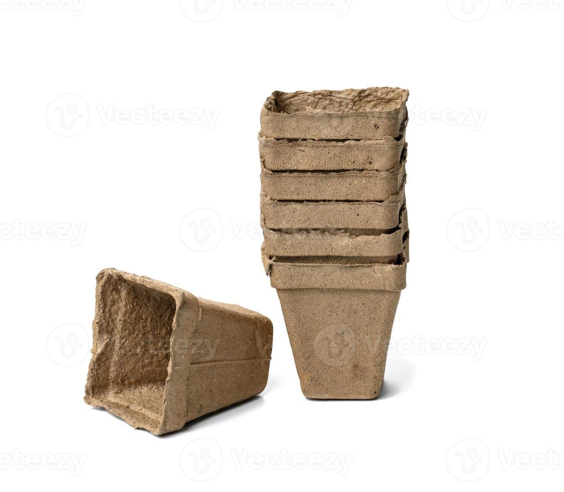 recyclable cardboard cups for planting seedlings and seeds isolated on white background. Ecological items, zero waste photo