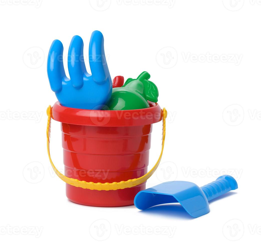 Baby red plastic bucket, shovel and rake on white background, set photo