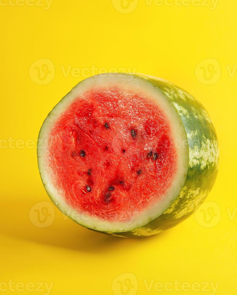 half round ripe red watermelon with brown seeds photo