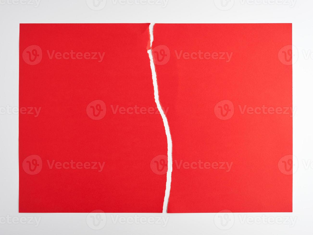 torn in half empty red sheet of paper on white background photo