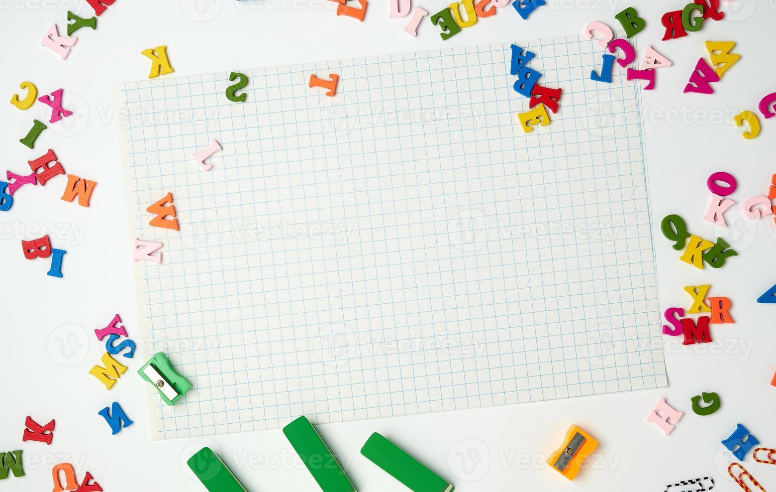 sheets in a cage and small multi-colored wooden letters photo