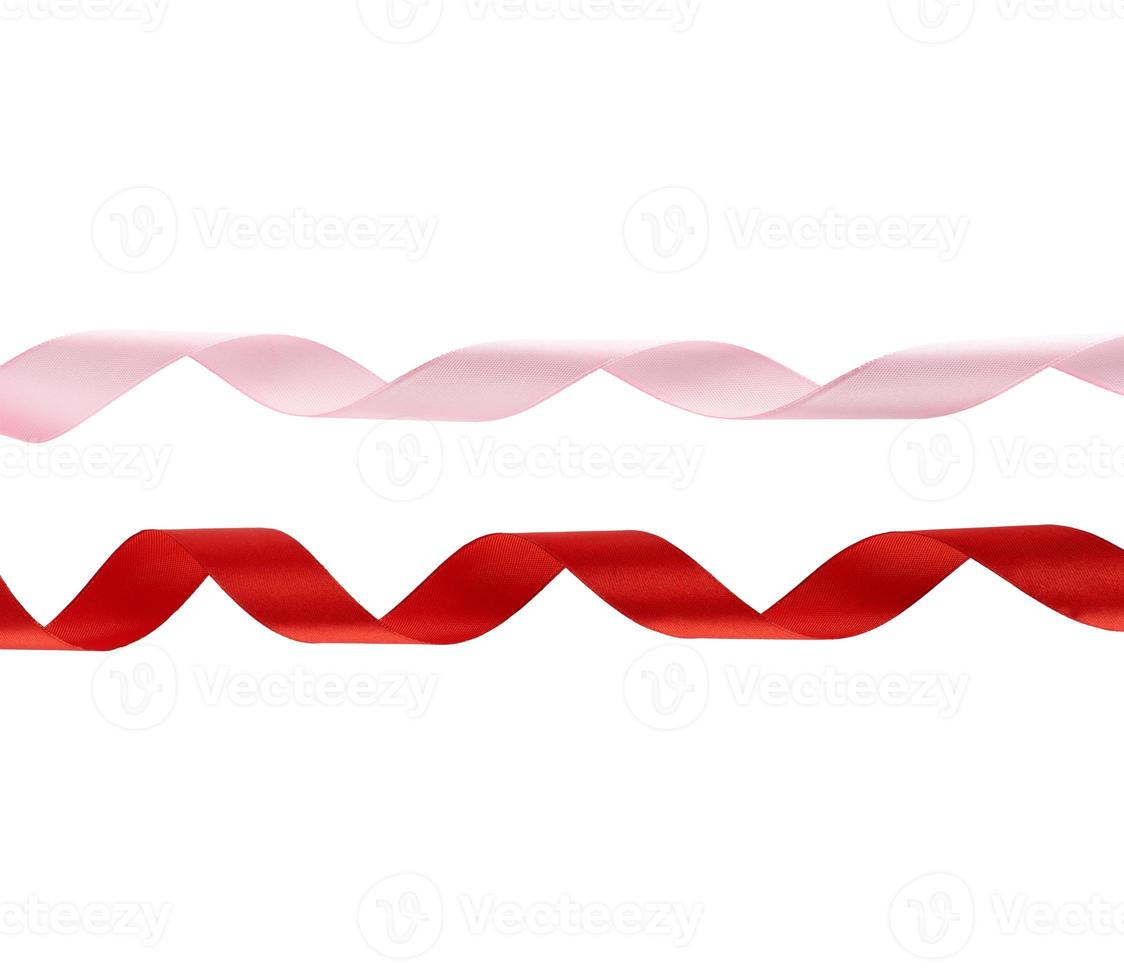 curled red and pink satin ribbons isolated on white background photo