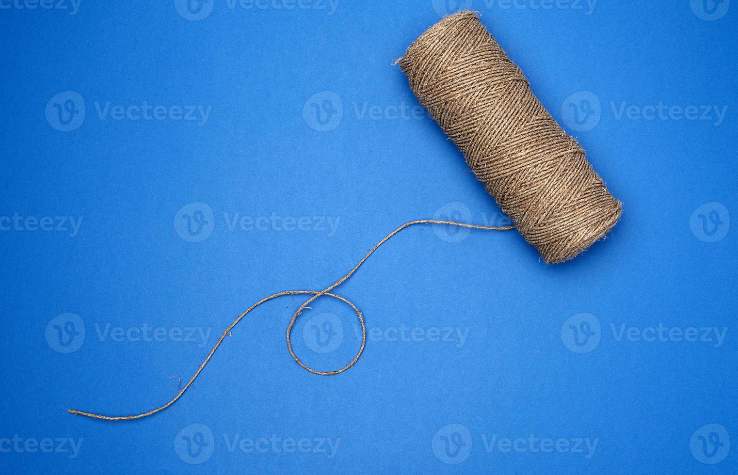 whole coil of twisted brown rope jute tourniquet, eco-friendly packaging photo