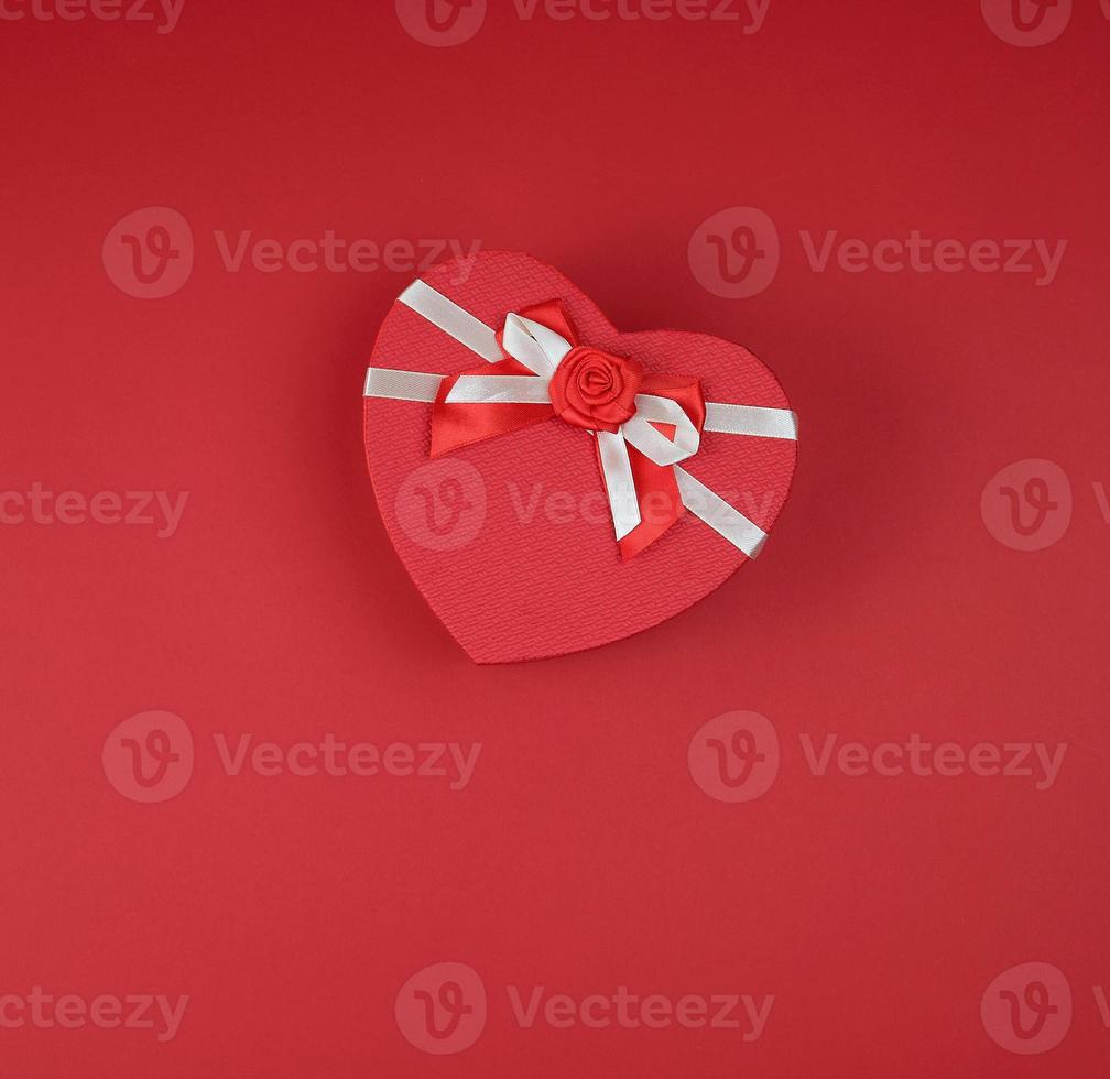 red gift box in the form of a heart with a bow photo