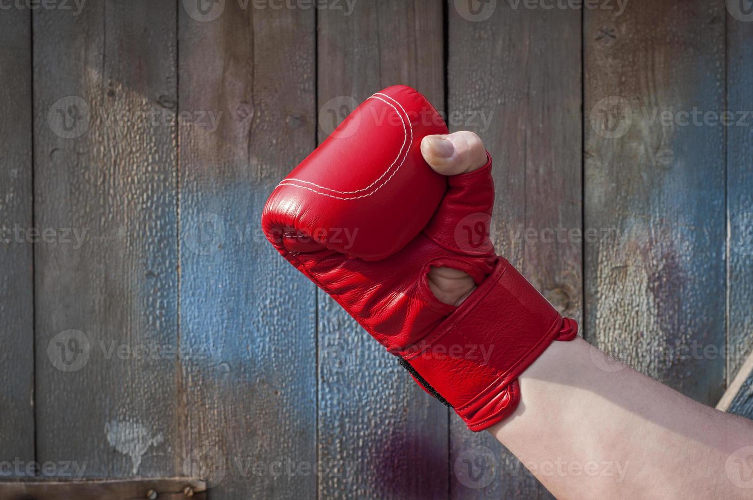 Man's hand in red boxing gloves photo