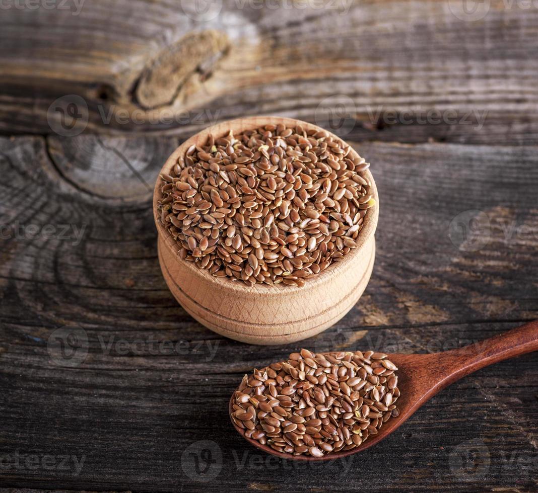 flax seeds in a wooden bowl and spoon photo