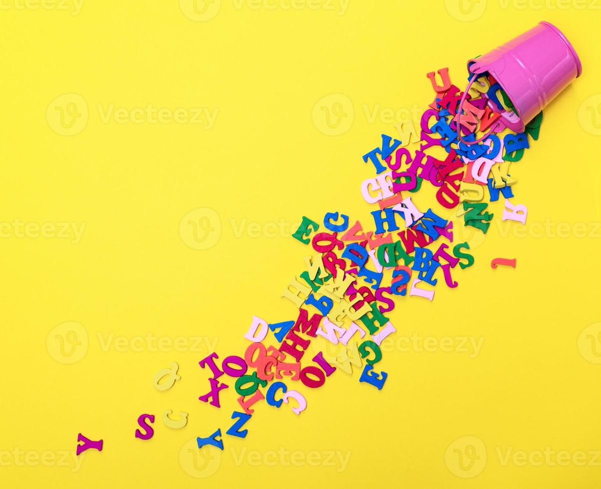 scattered wooden multicolored letters of the English alphabet photo