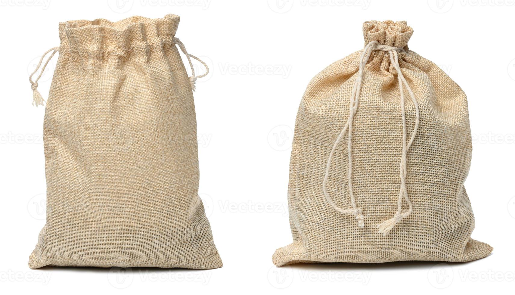 Full canvas bag tied with rope and isolated on a white background photo