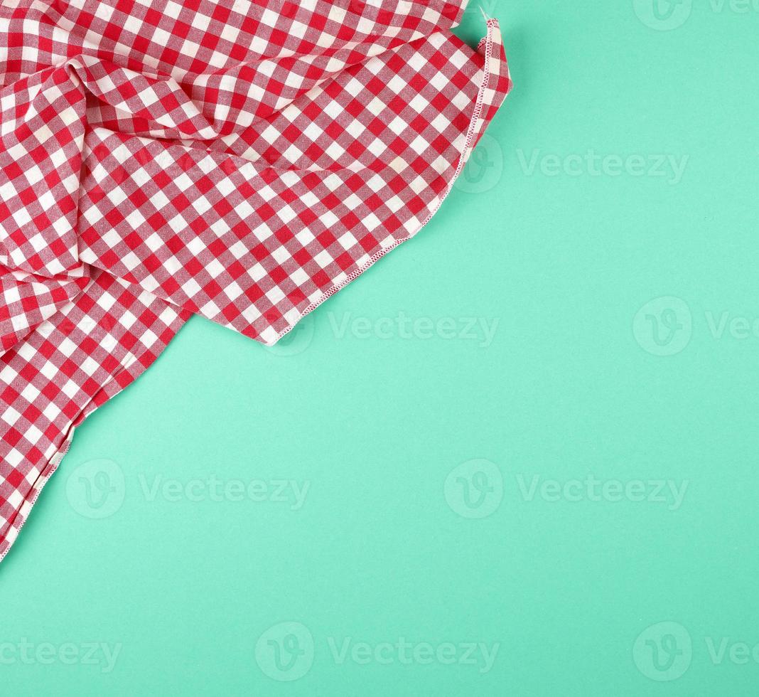 white red checkered kitchen towel on a green background photo