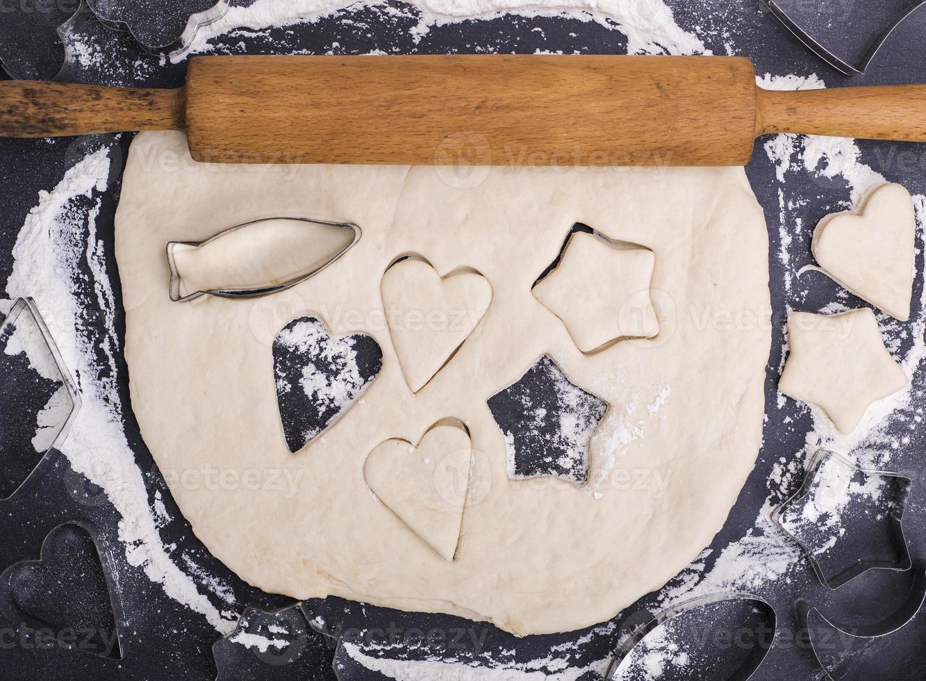 rolled up dough with a wooden rolling pin for a cookie photo