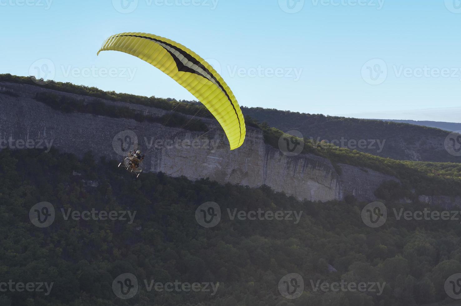 Paraglider flying over mountains photo