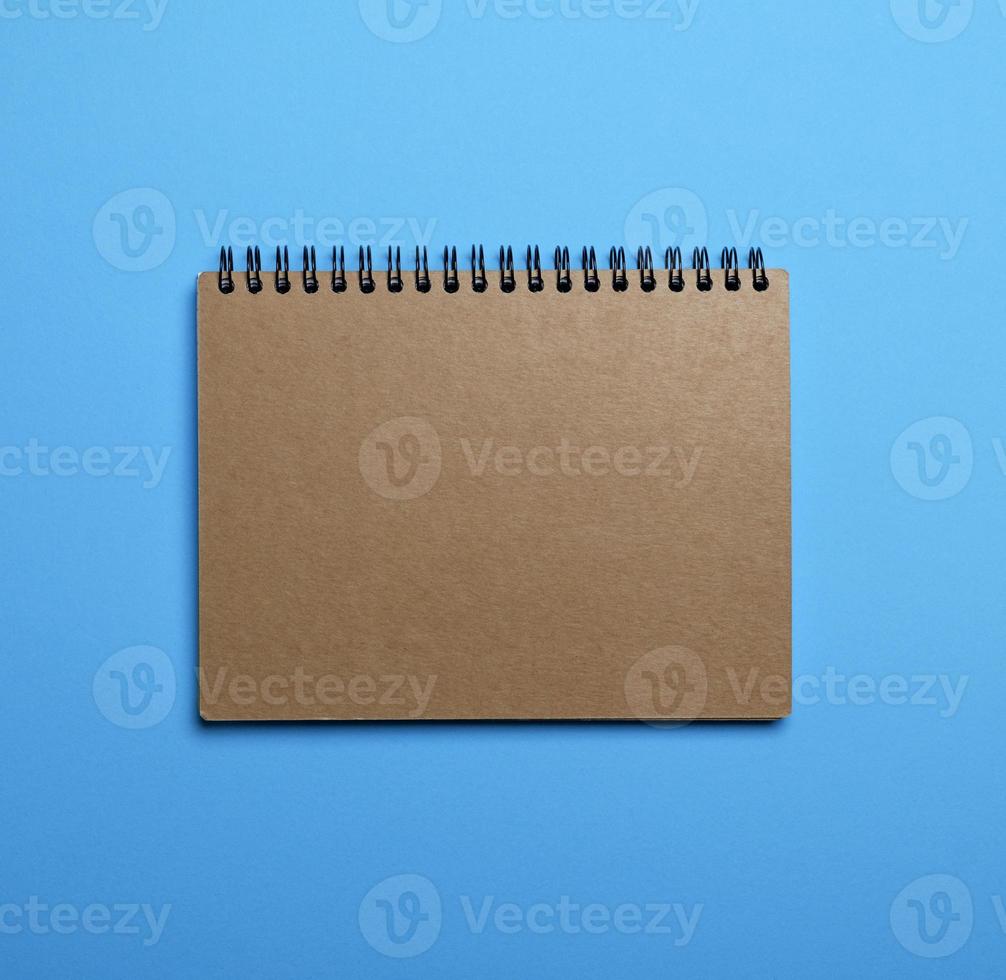 notebook on a black iron spring with brown empty sheets photo