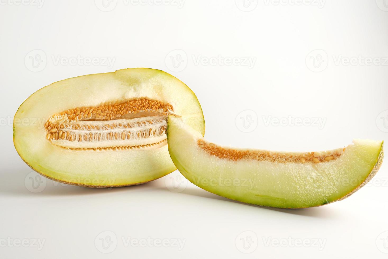 piece of ripe melon with seeds on a white background photo