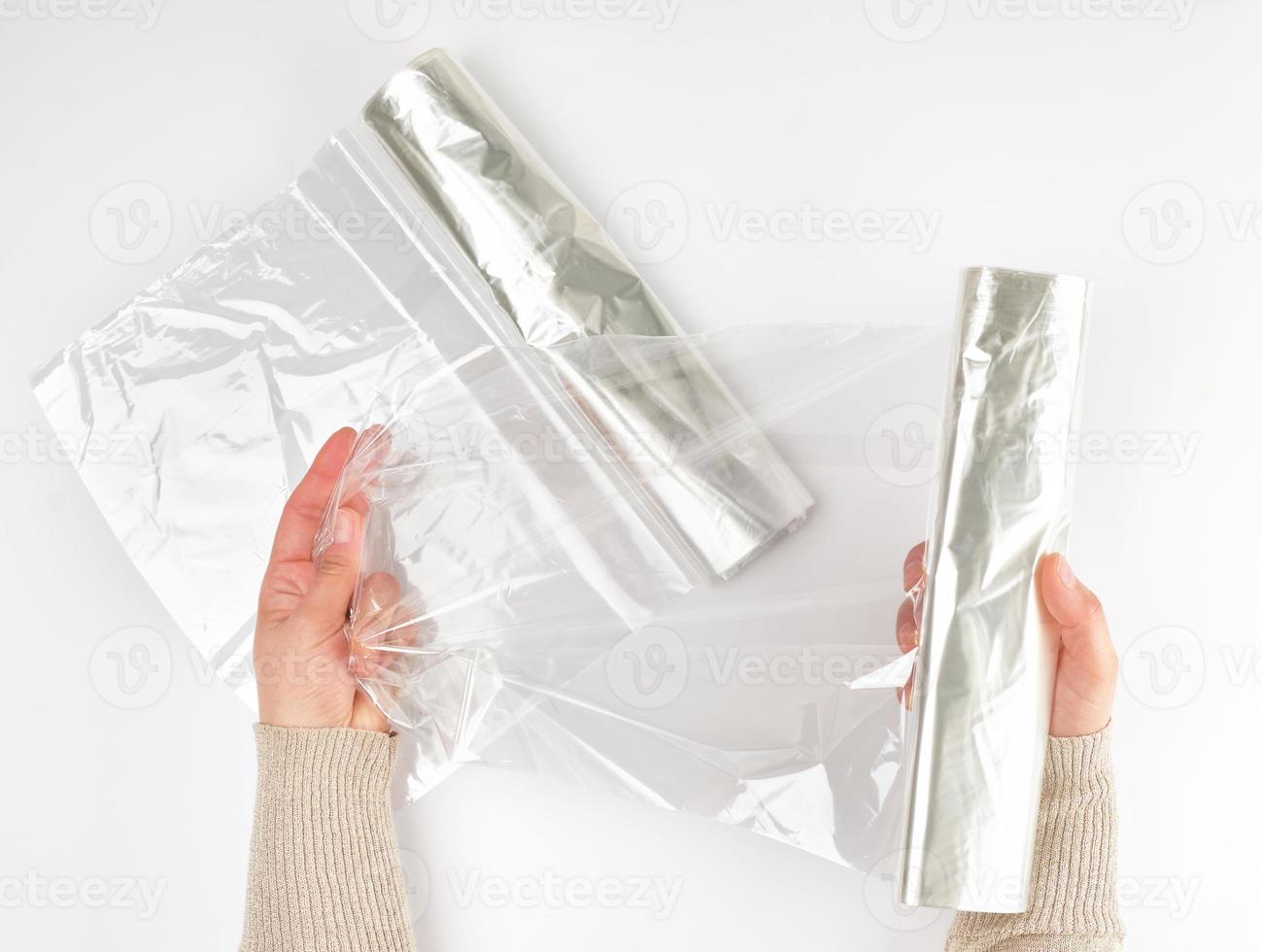 Plastic food wrap for baking products in the oven in women's hand photo