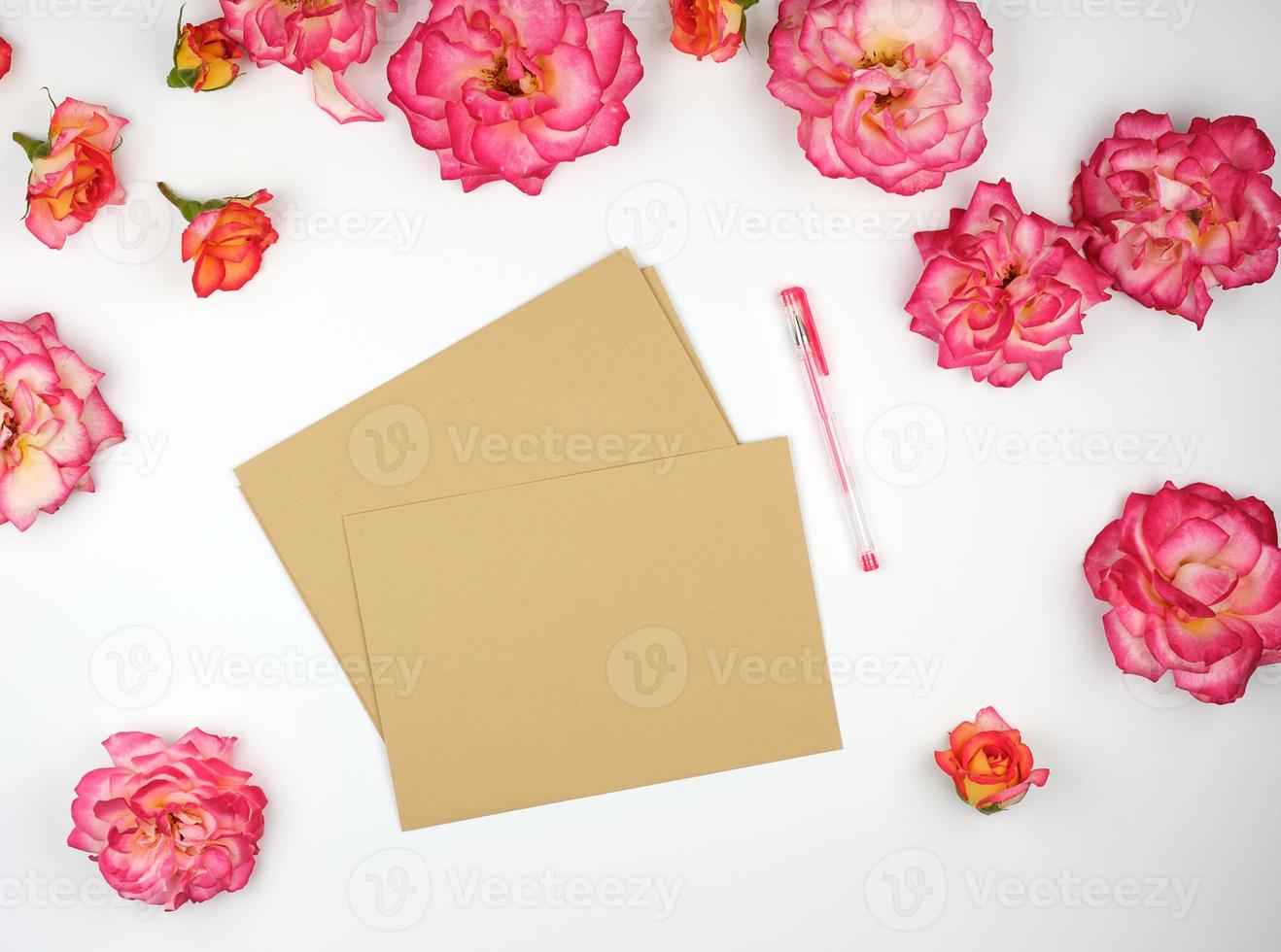 pink rose buds and a brown paper envelope photo