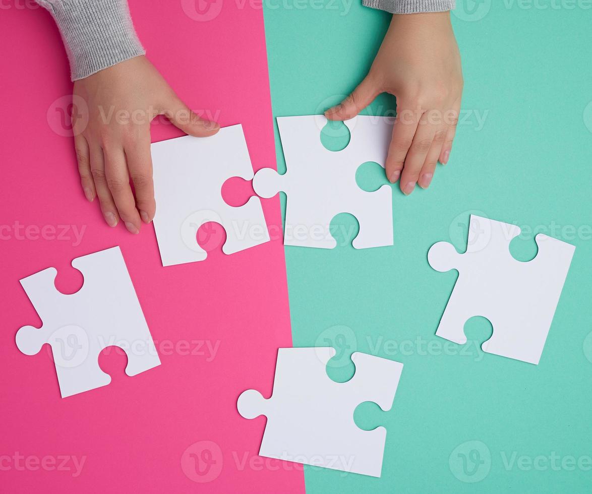 empty paper white pieces of puzzles in female hands, puzzle connected photo