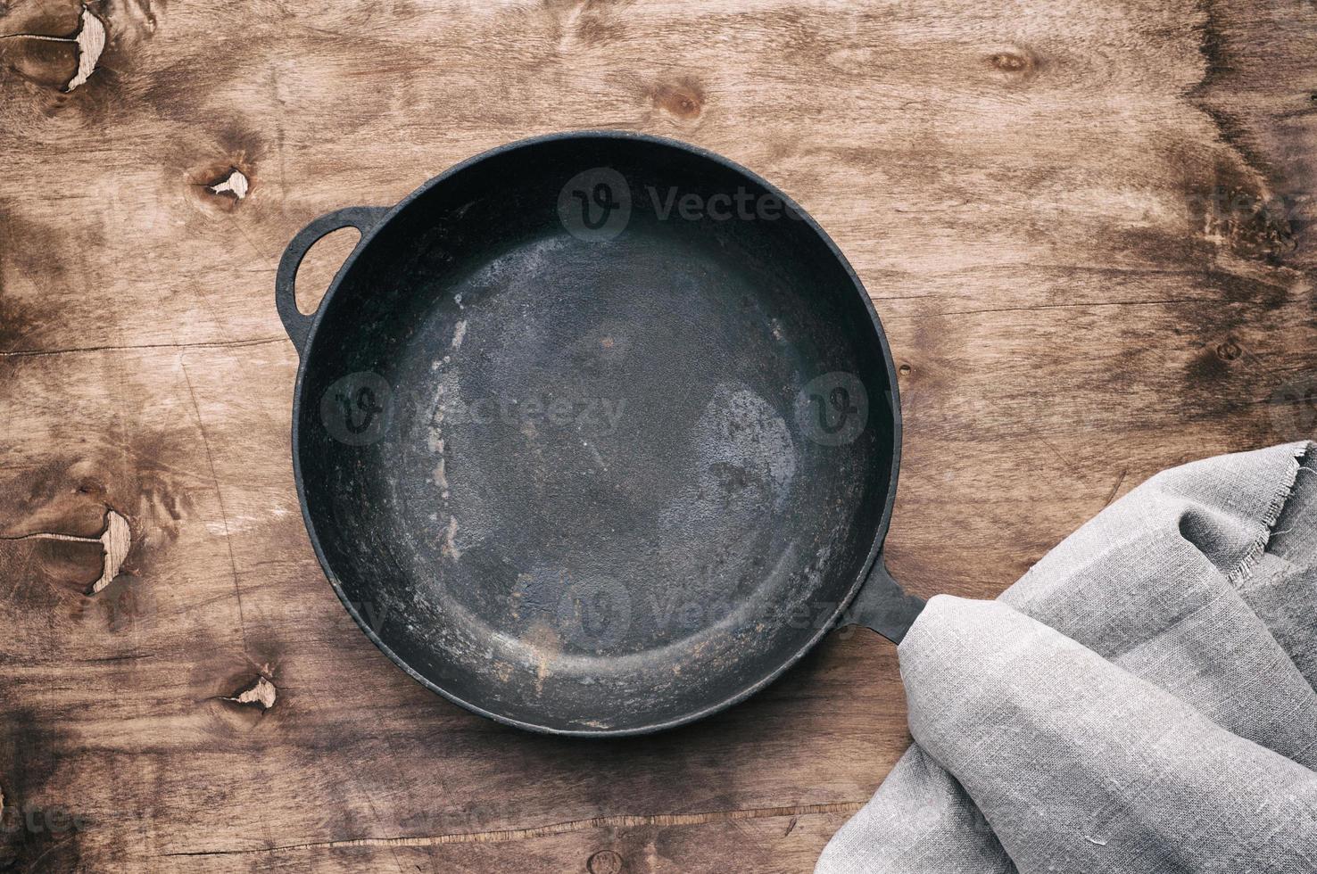 empty round black cast-iron frying pan photo