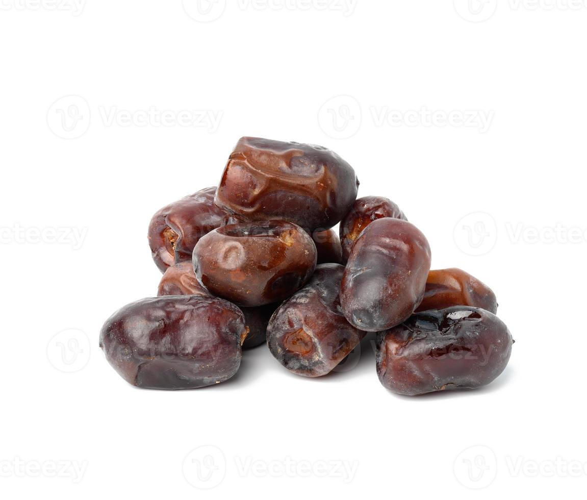 A pile of dried dates on a white background, grade Mazafati photo