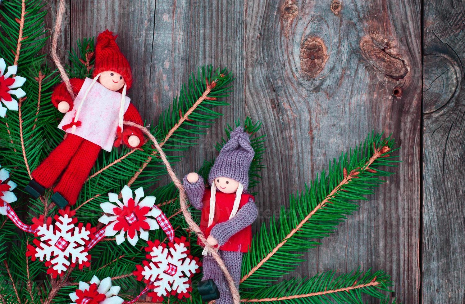 branch of fir with decoration on a gray wooden background photo