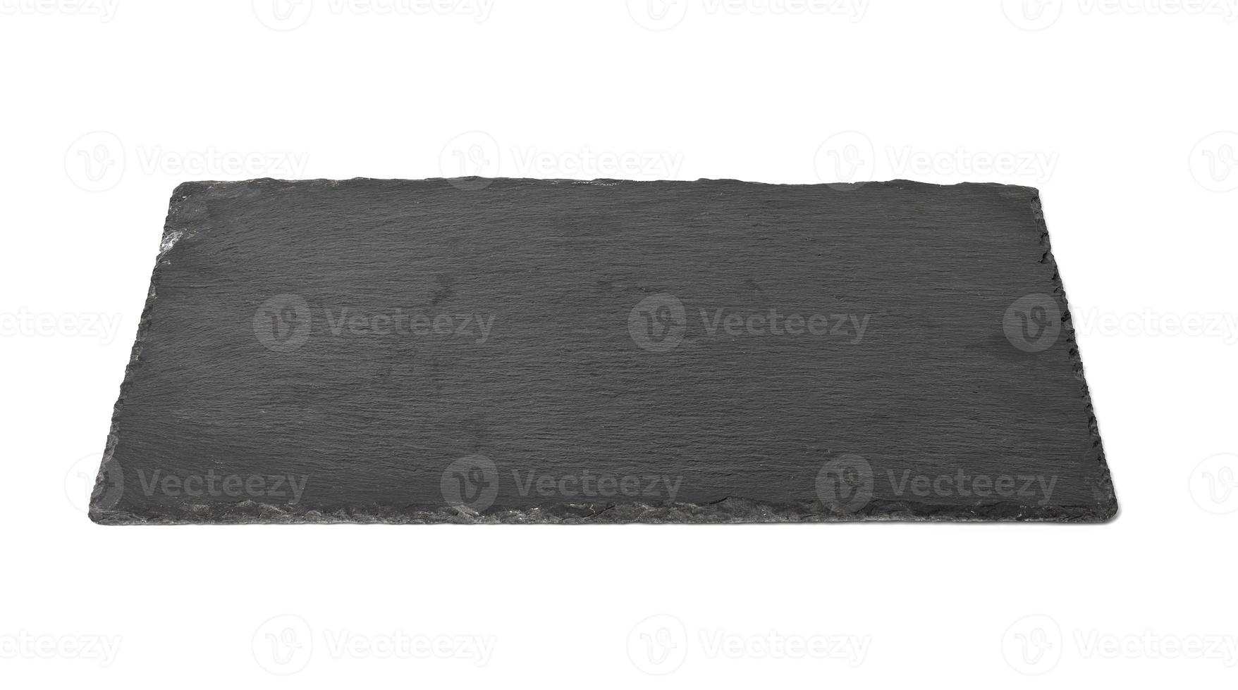 big rectangular black slate stone board isolated on white background, utensils for serving food photo