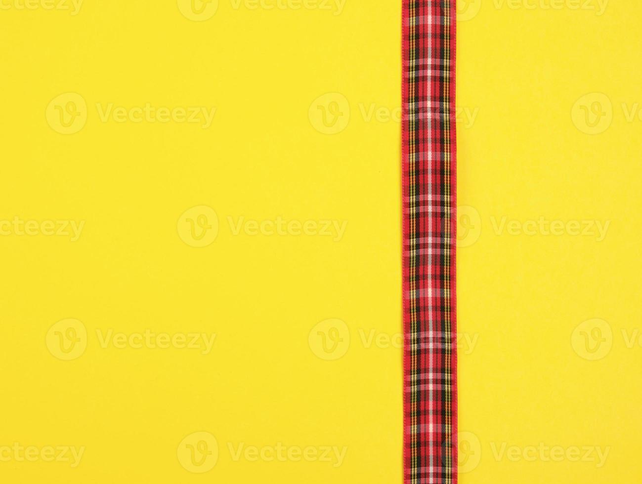 red ribbon in the box on a yellow background photo