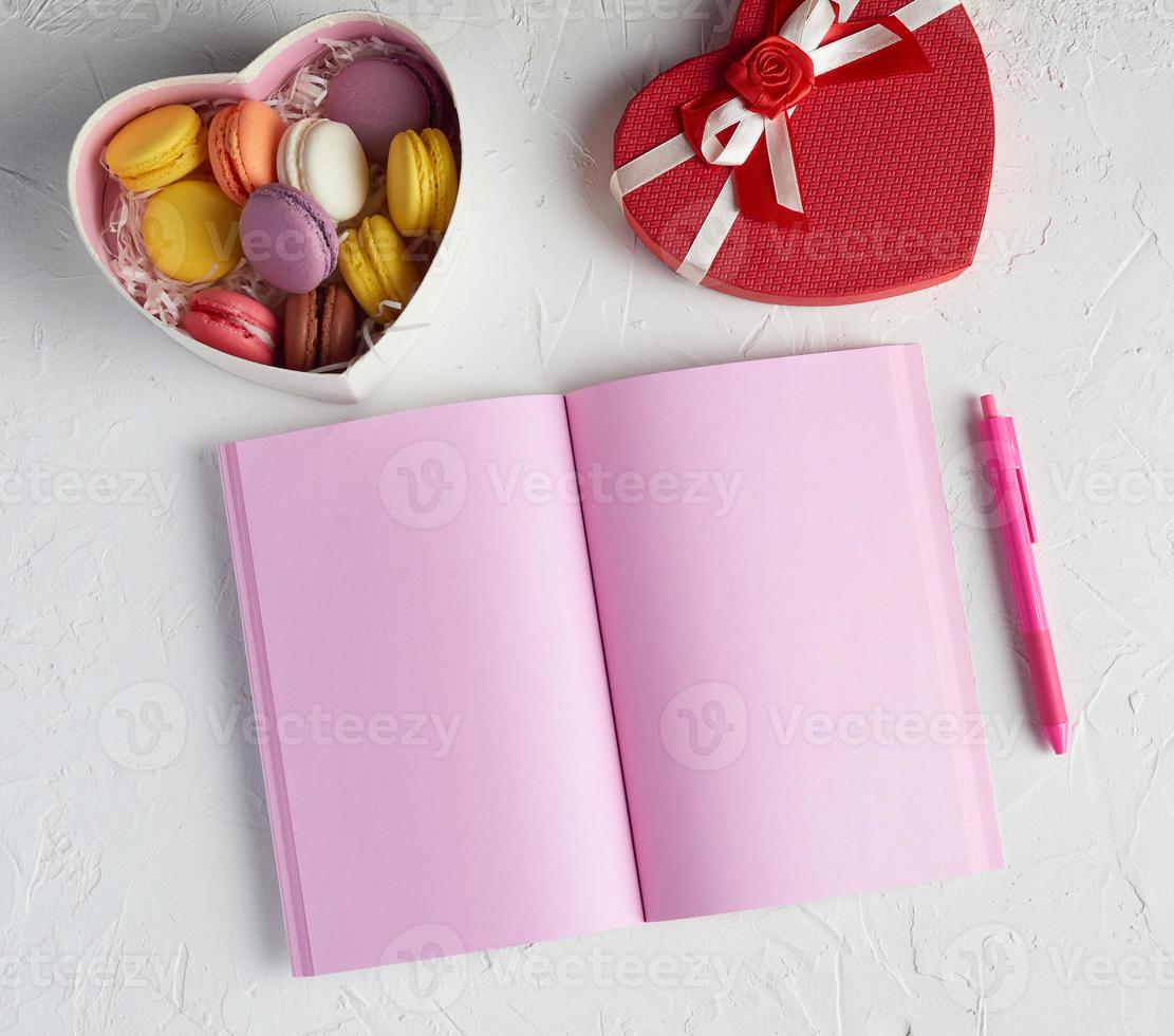 open notebook with blank pink pages, red pencil photo
