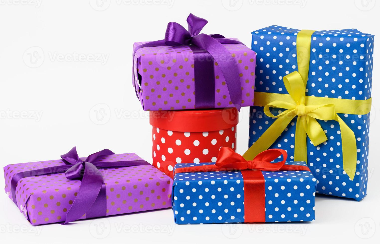 stack of boxes wrapped in paper and tied with a silk ribbon on a white background, celebration photo