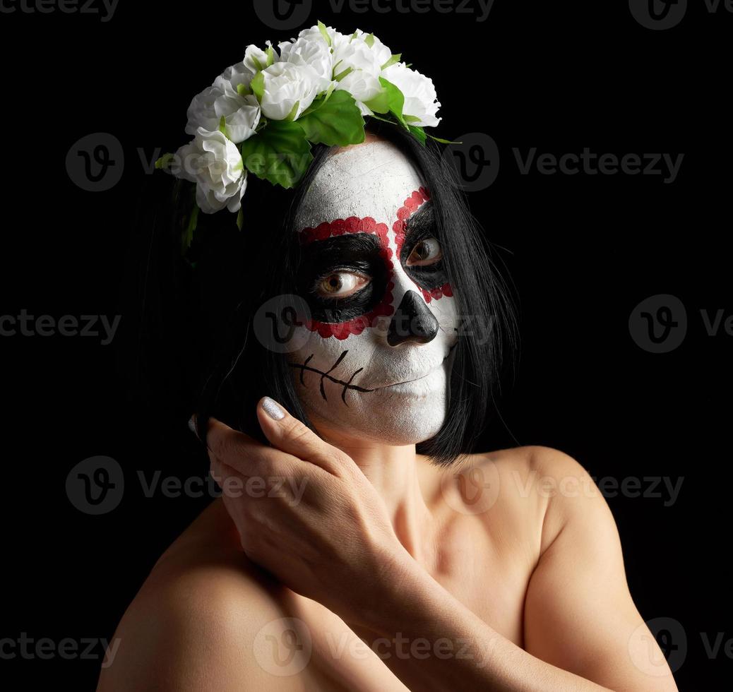 Young beautiful girl with traditional mexican death mask photo