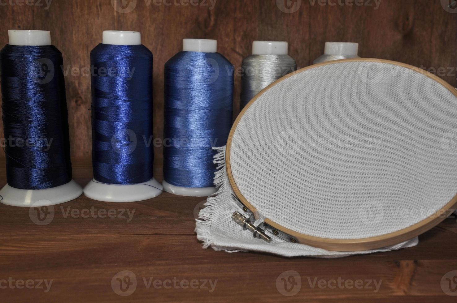 Set for embroidery of colorful threads, hoops, thimble and need photo