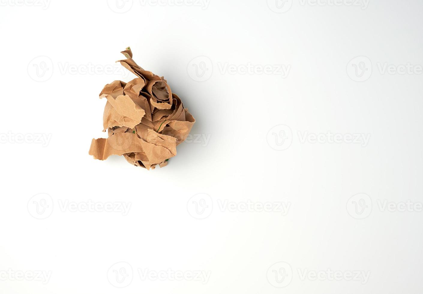 crumpled sheet of brown paper on a white background photo