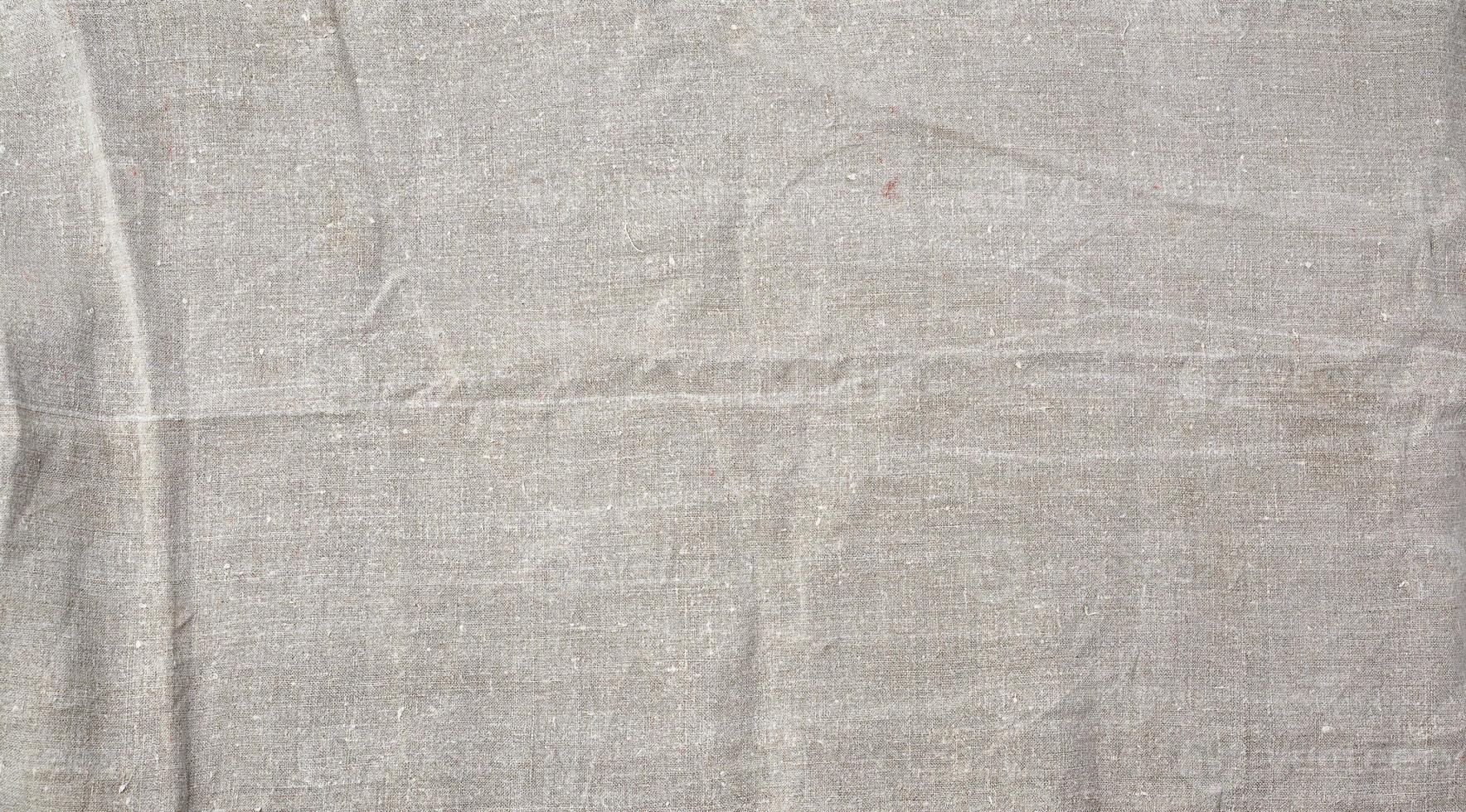 fragment of a very old gray linen homespun fabric photo