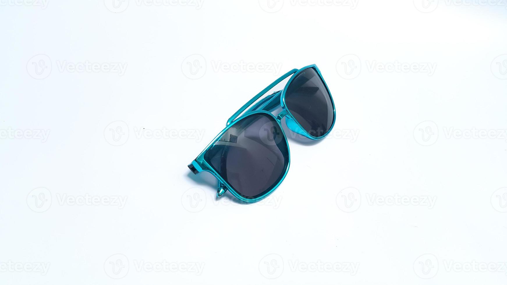 Fashion female sunglasses isolated on white background. Sunglasses with a turquoise frame photo