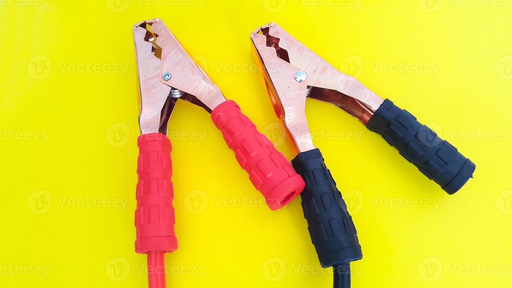 Red and black car battery jumper cable or booster cables isolated on