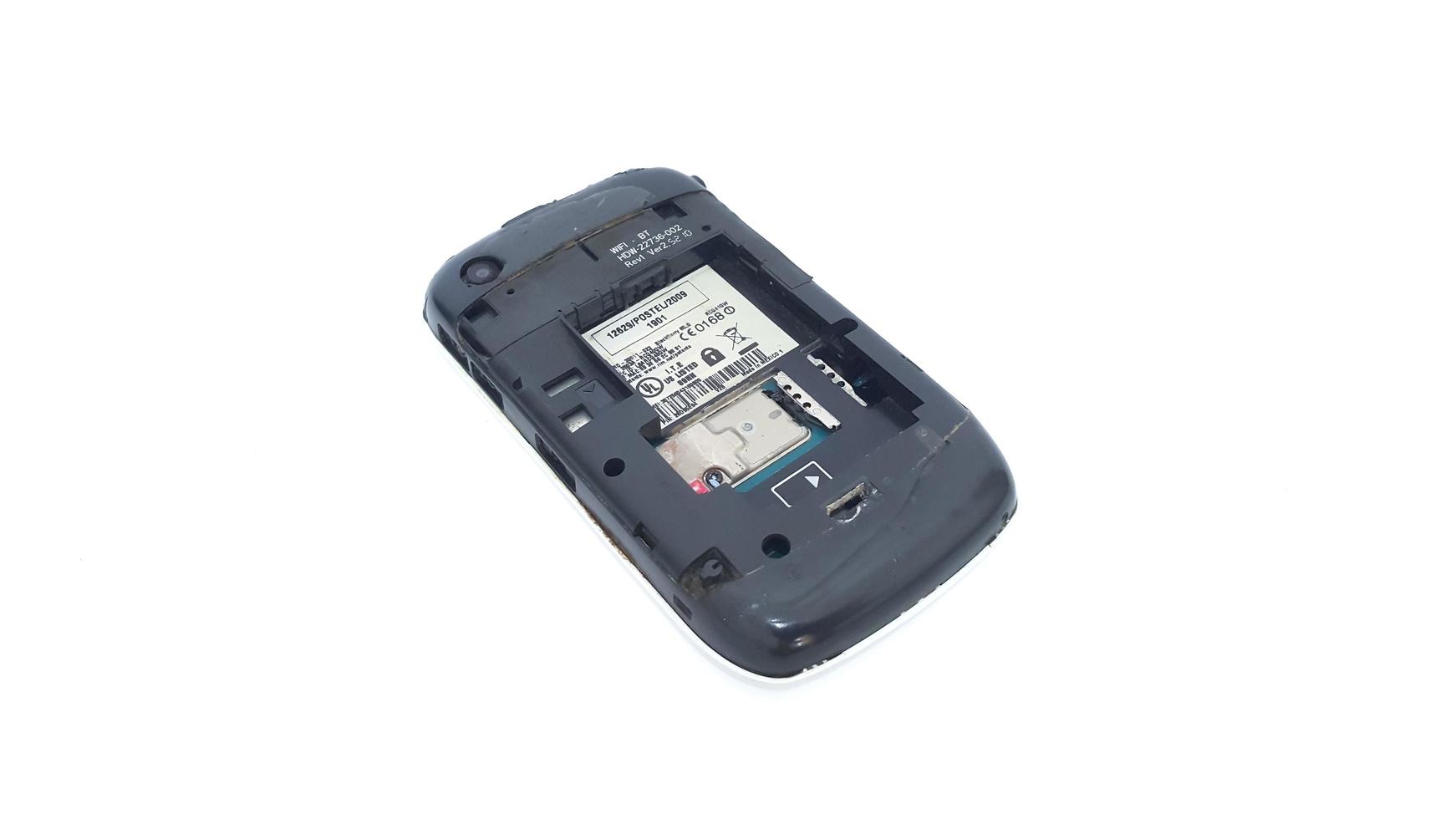 Jakarta, Indonesia, 2023 - The back of obsolete Blackberry mobile phone isolated on white background. Blackberry 8520 Gemini series. No battery. photo