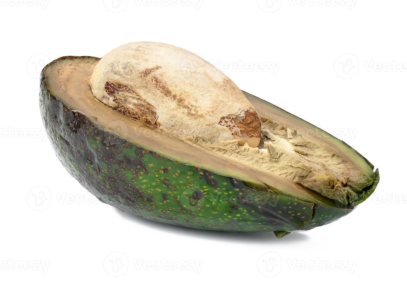 Half of rotten avocado with pit isolated on white background photo