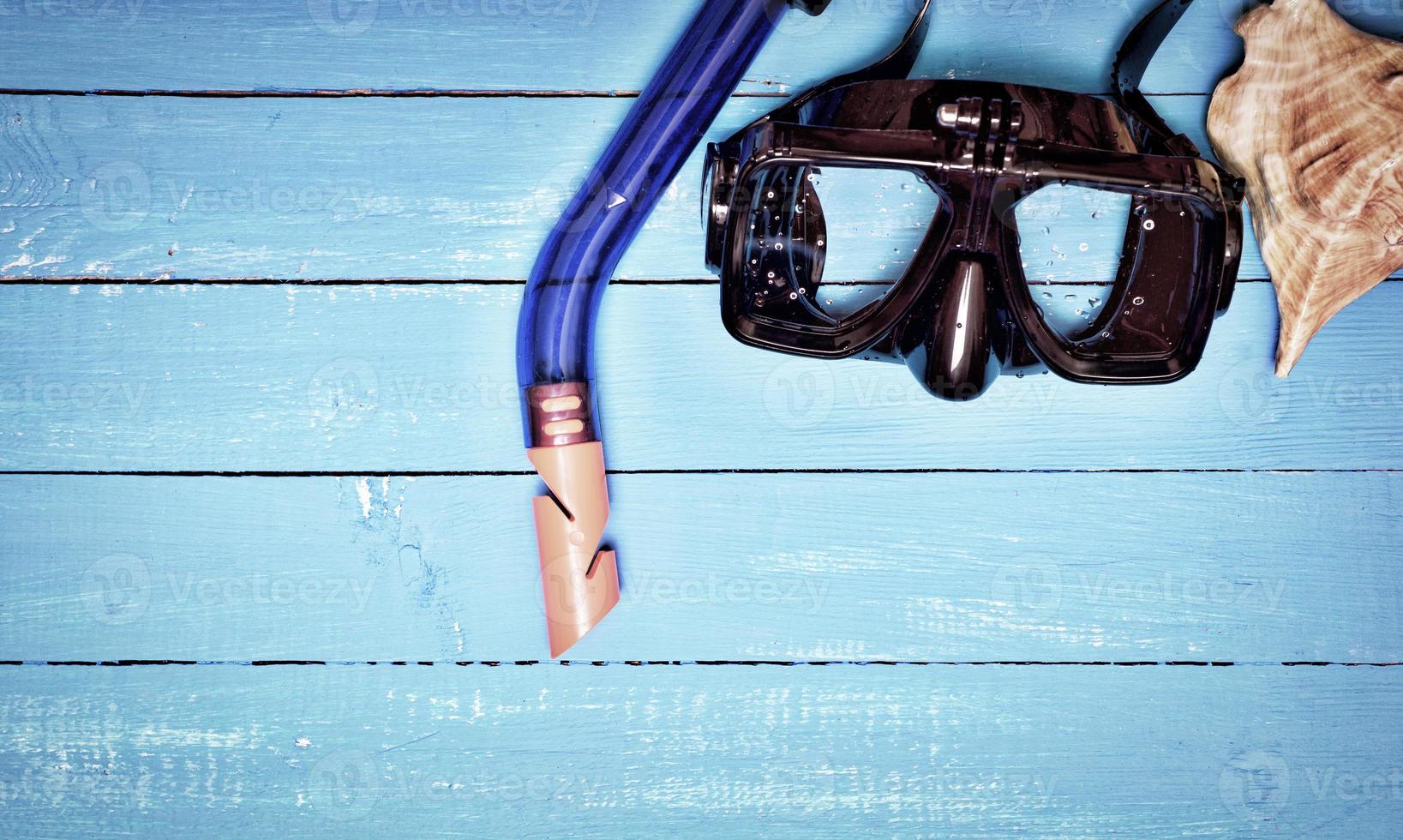 scuba mask and snorkel on a blue wooden background photo