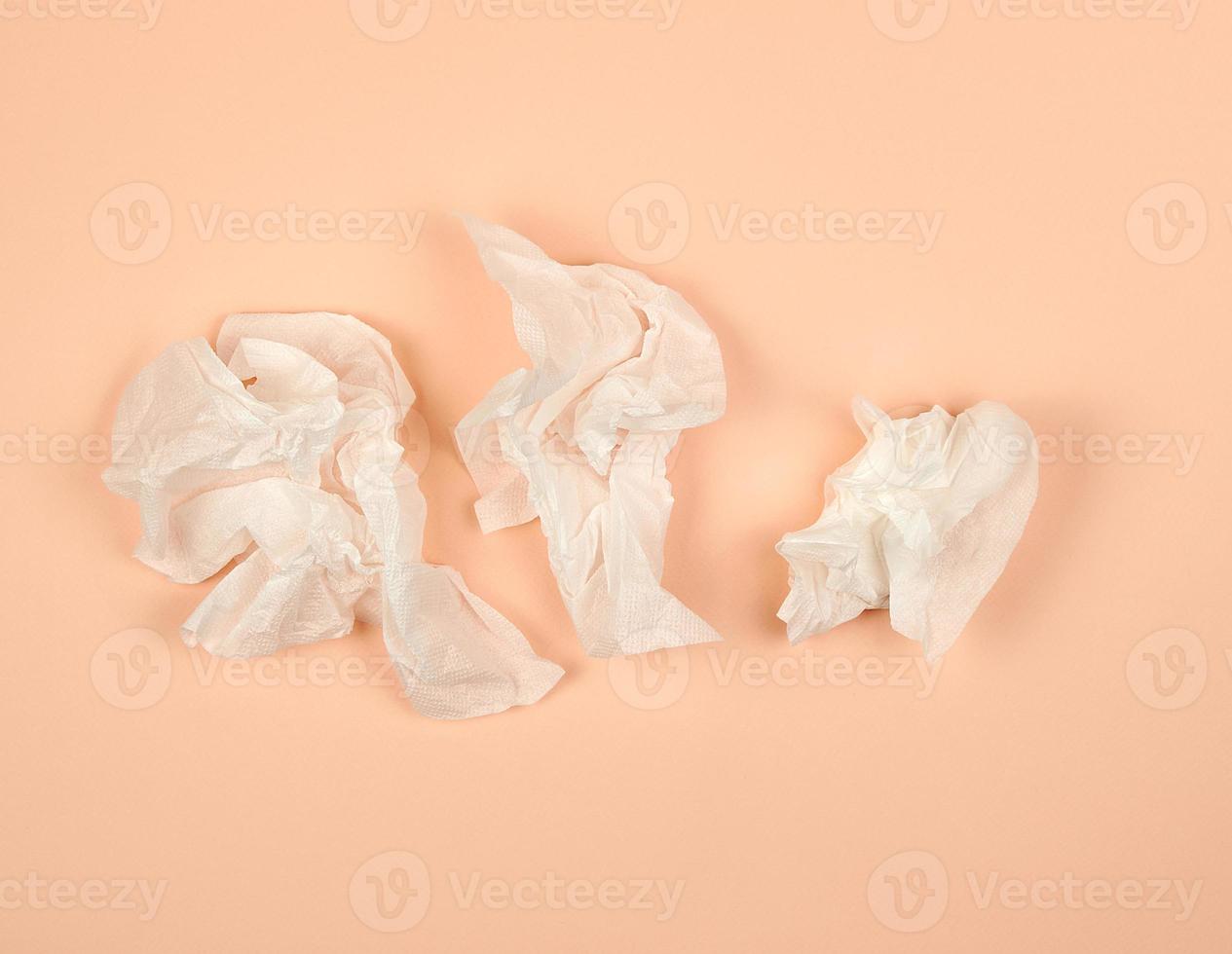 crumpled white paper napkins on a beige background photo