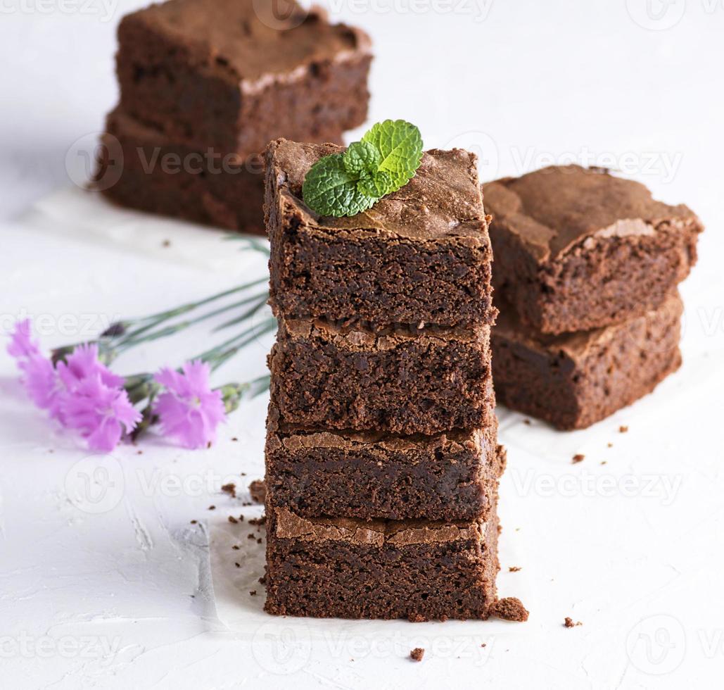 stack of square pieces of baked brown brownie pie photo