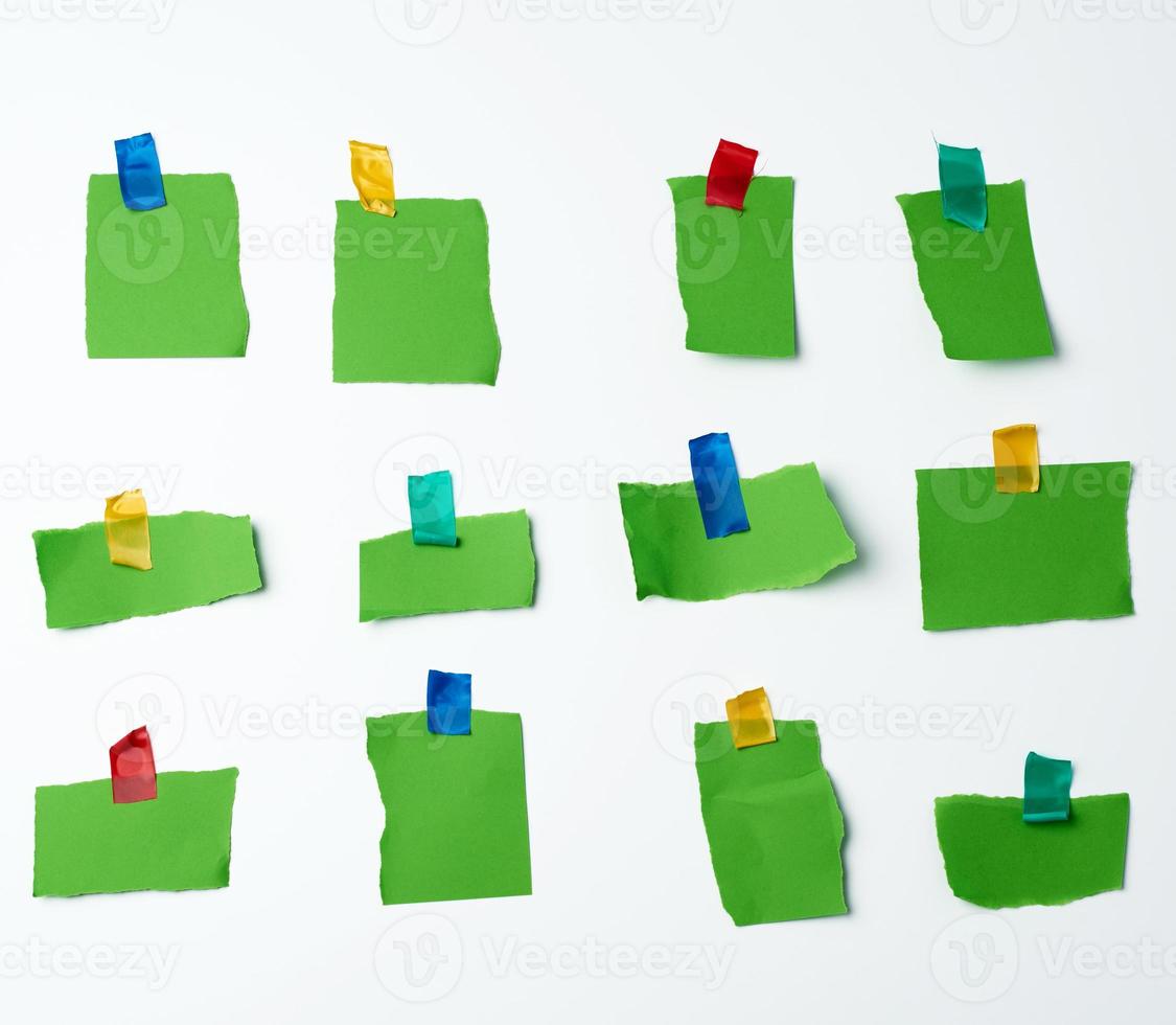 lot of torn green pieces of paper glued with scotch tape photo
