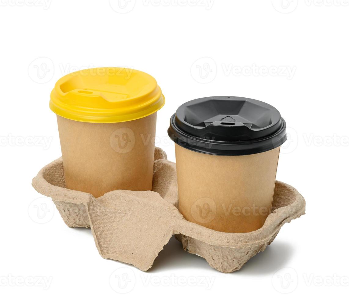 disposable brown cups with plastic lid stand in holder on white background photo