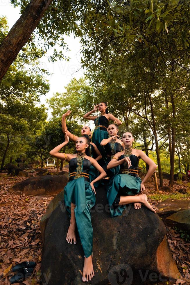 A Group of Balinese people wearing traditional green costume before the dance festival begin photo