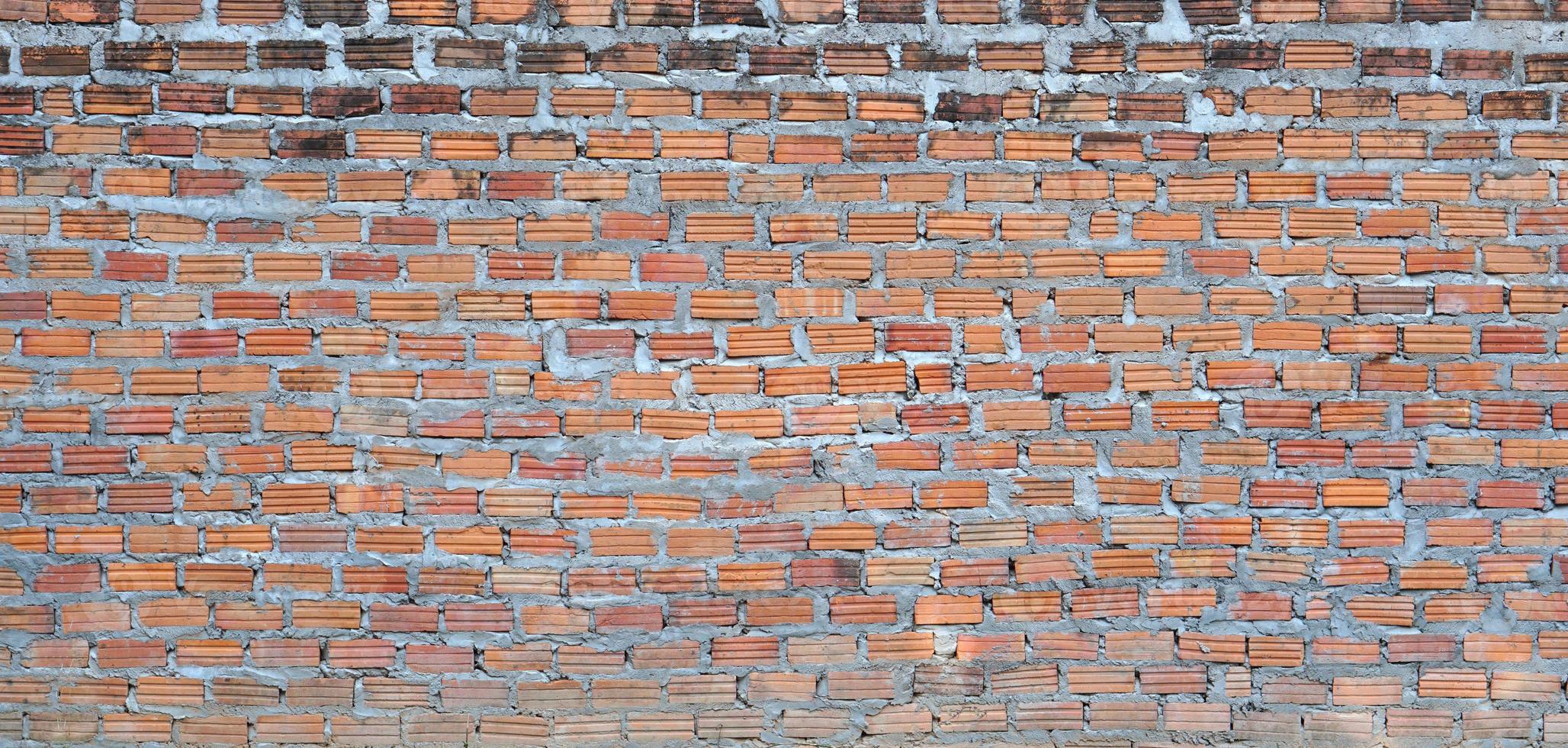 Red brick wall. Texture of old dark brown and red brick wall  backgorund. photo
