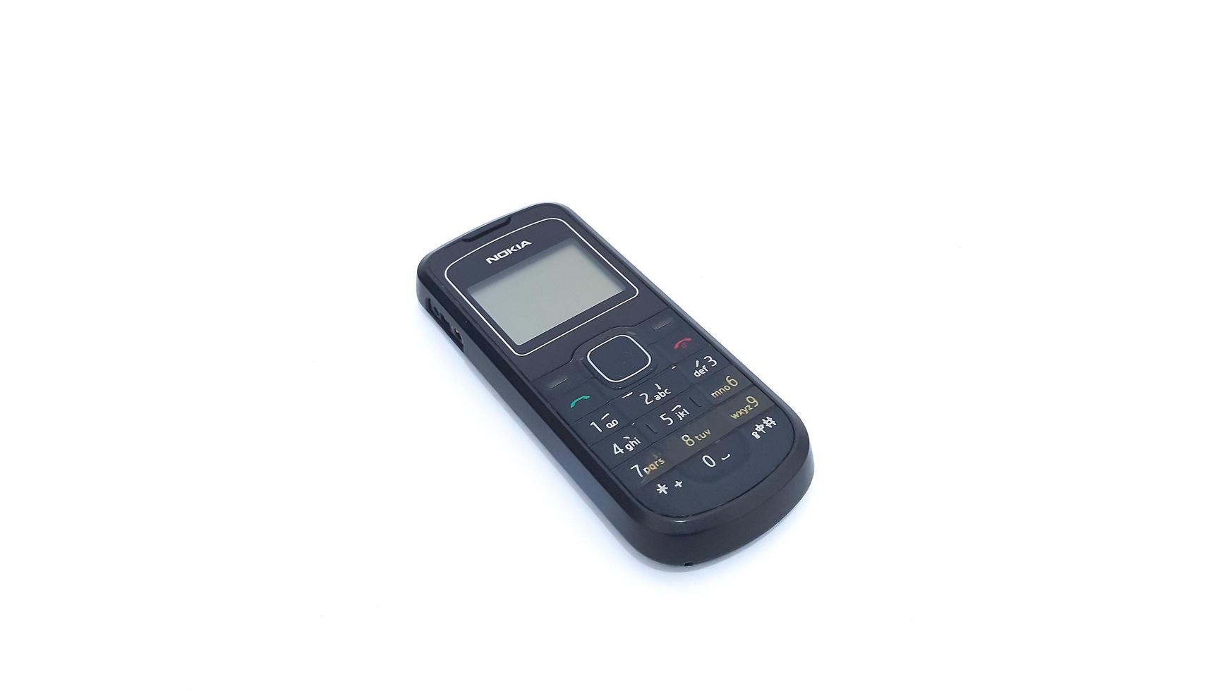 Jakarta, Indonesia, 2023 - Close up of old Nokia cell phone isolated on white background. Nokia 1202 series. photo