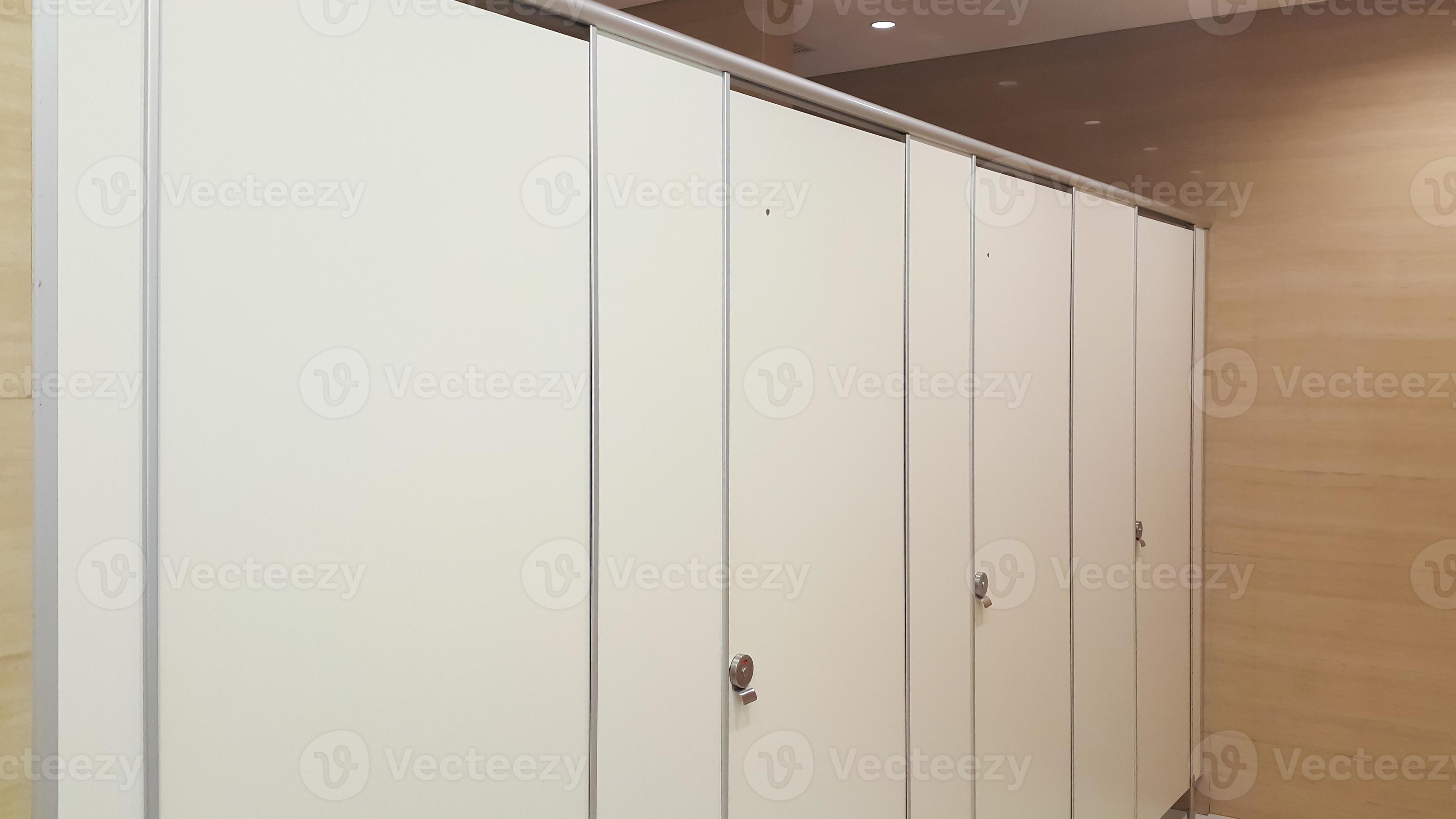 Separated toilets at public restroom. Public toilet booth. Closed door