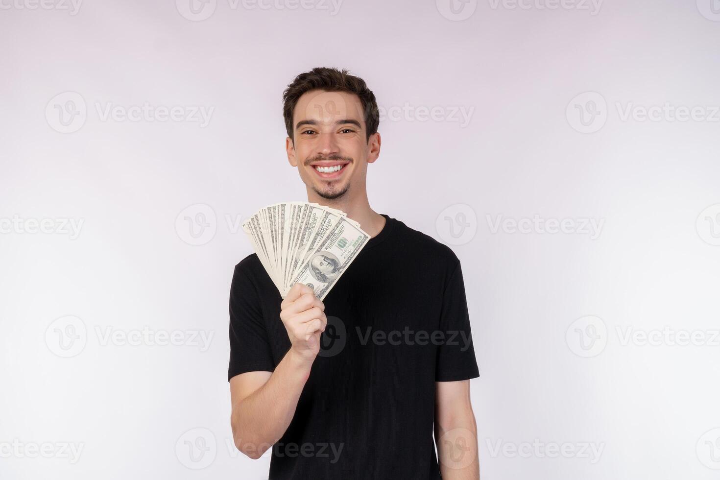 Portrait of a cheerful man holding dollar bills over white background photo