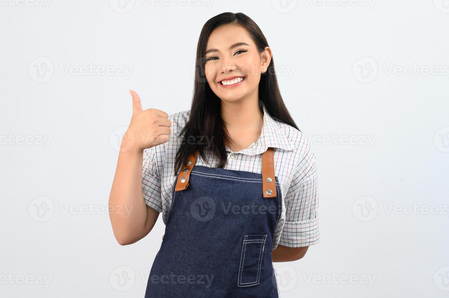 Portrait Asian young woman in waitress uniform with thumb up posture photo